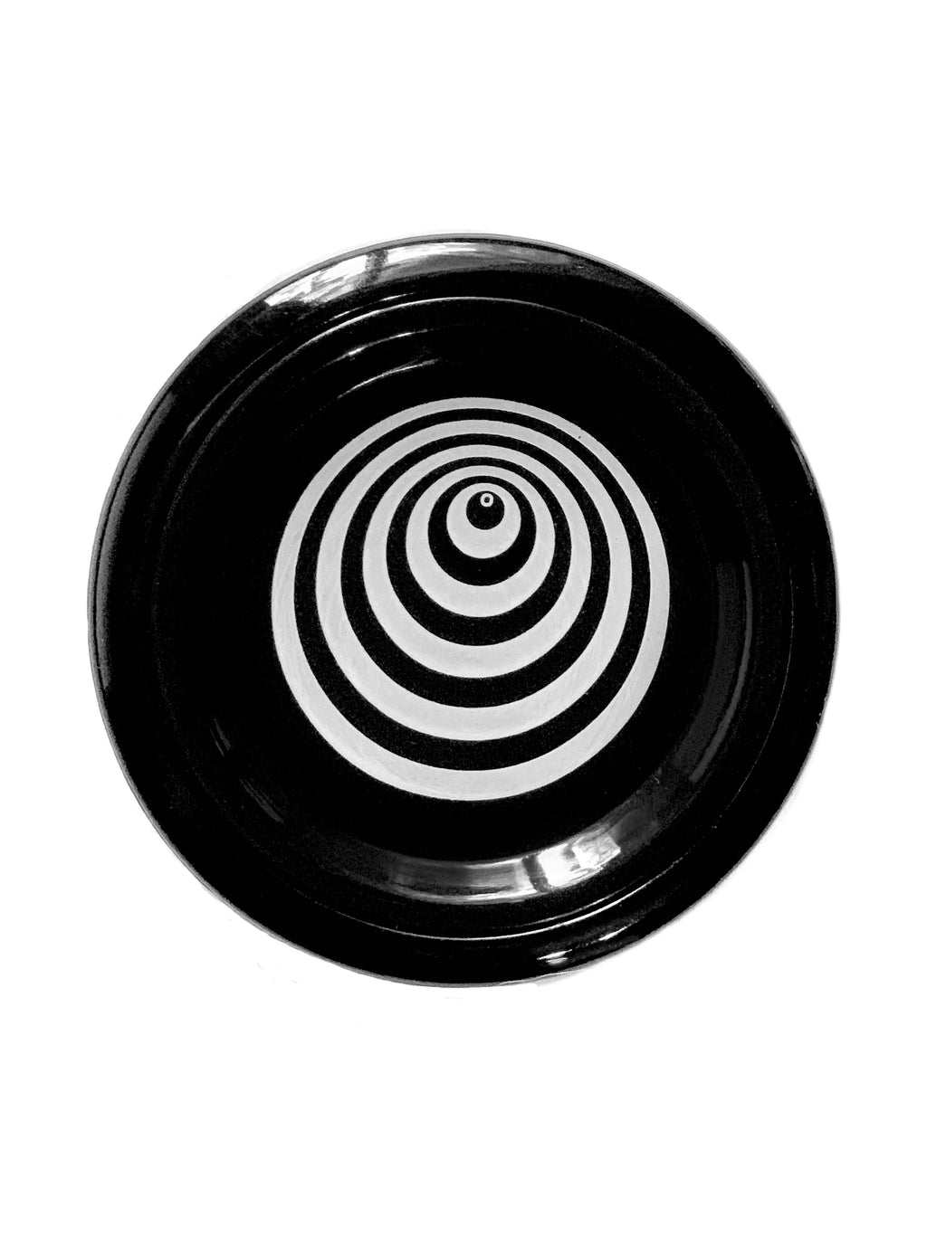 A black plastic yo-yo with a wormhole optical illusion in white in the middle.