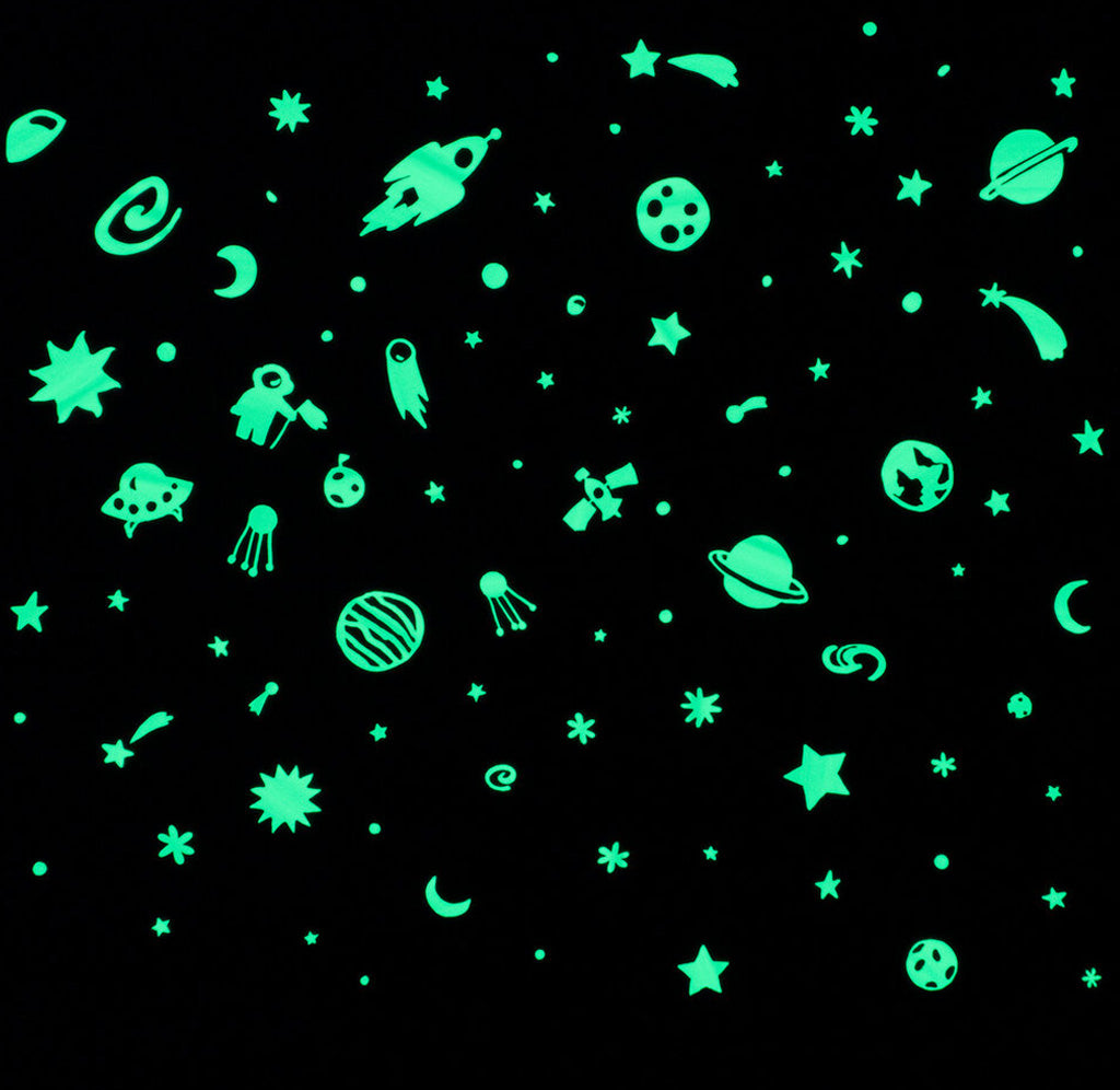 Glow-in-the-dark space-themed stickers depict galaxies, moons, shooting stars, astronauts, Earth, UFOs, rockets, stars, and satellites against a black background.