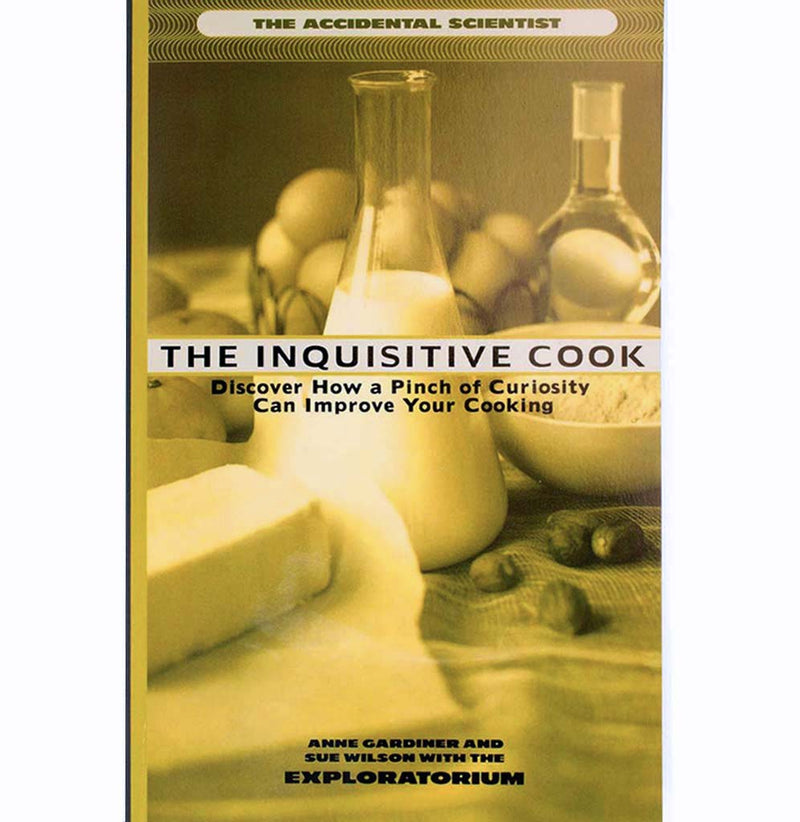 A paperback book with a photograph of a table setting with different baking ingredients, such as milk, butter, and eggs tinted yellow.