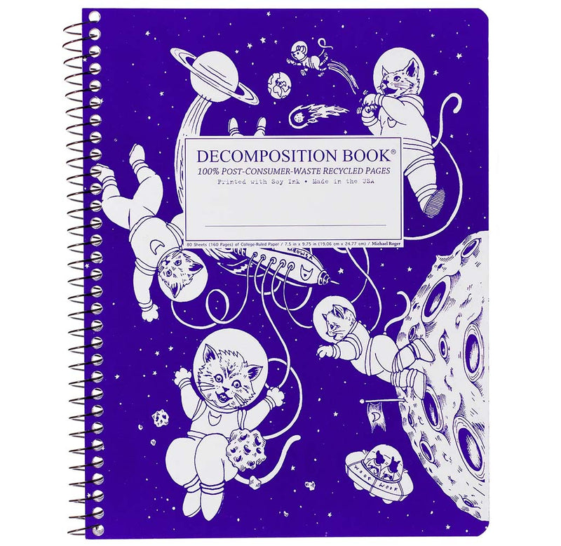 A spiral-bound purple background notebook with white kittens in space suits flying through space amongst the planets.