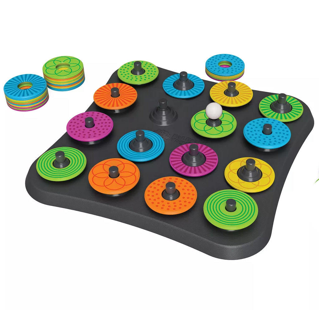 The gameboard is set up for play with fifteen different textured colored discs. There is one white ball and a black game board; extra discs sit to the side