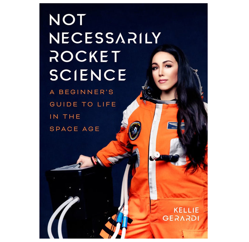 "Not Necessarily Rocket Science" is a hardback book with a black cover; Kellie Gerardi is on the cover wearing a Final Frontier Design orange spacesuit. 
