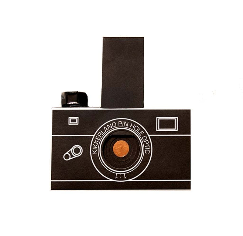 A black 35 mm film camera's made from paper with a copper pinhole where the light exposes the film.