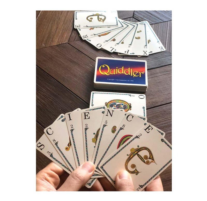 The card game is set up for gameplay; player one has spelled out science, the game cards are on the table, and player two cards are on the table.