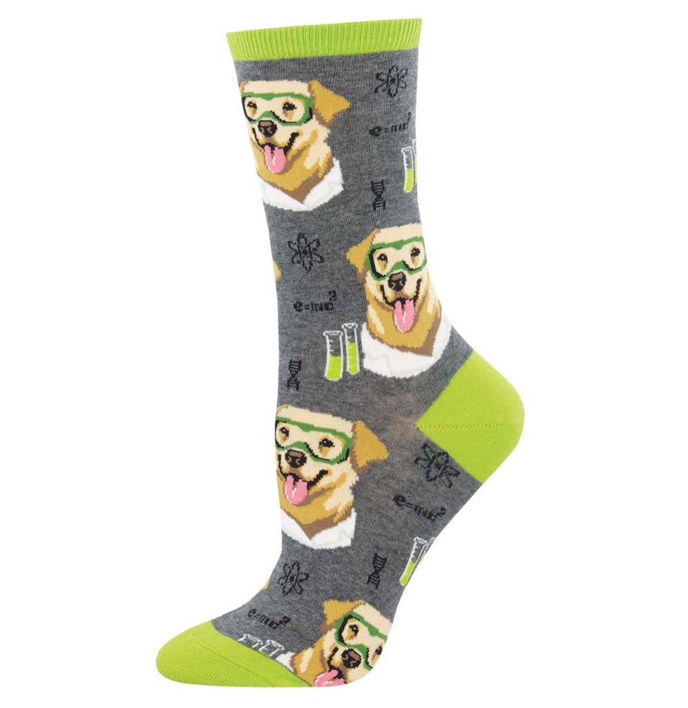 The background of the sock is dark gray, there is a yellow lab in a laboratory coat, and laboratory equipment sits in duplicates on the sock; the cuff, toe, and heel are green.