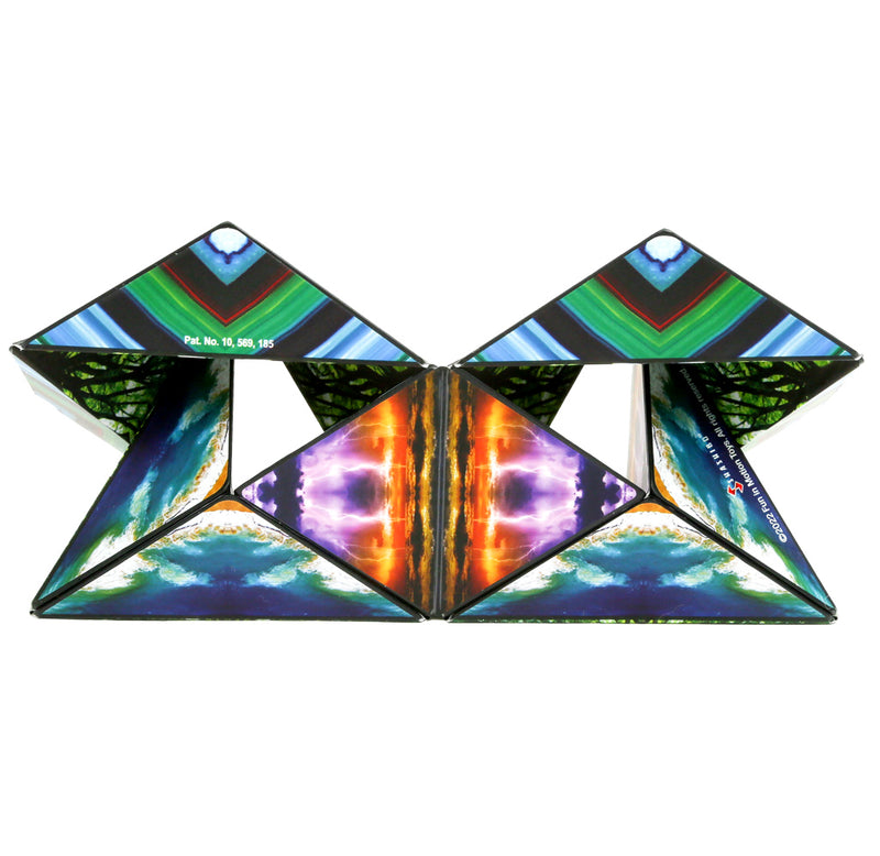 The elements Shashibo is set up in a long triangular design with three sides showing purple lighting strikes over the yellow ocean, a multi-colored mineral, and an aerial view of islands surrounded by sea.