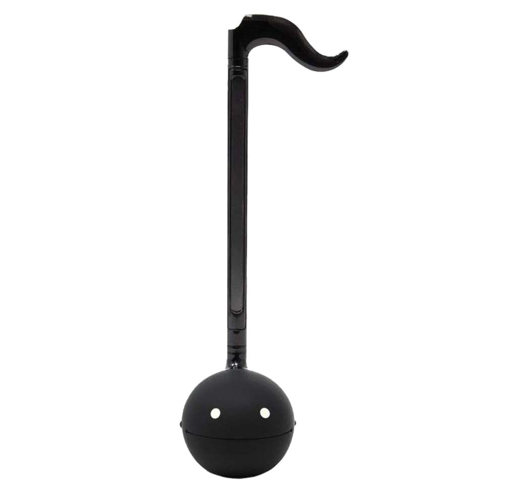 A long slender black musical instrument that is in the shape of an eight note with white eyes on the base. 